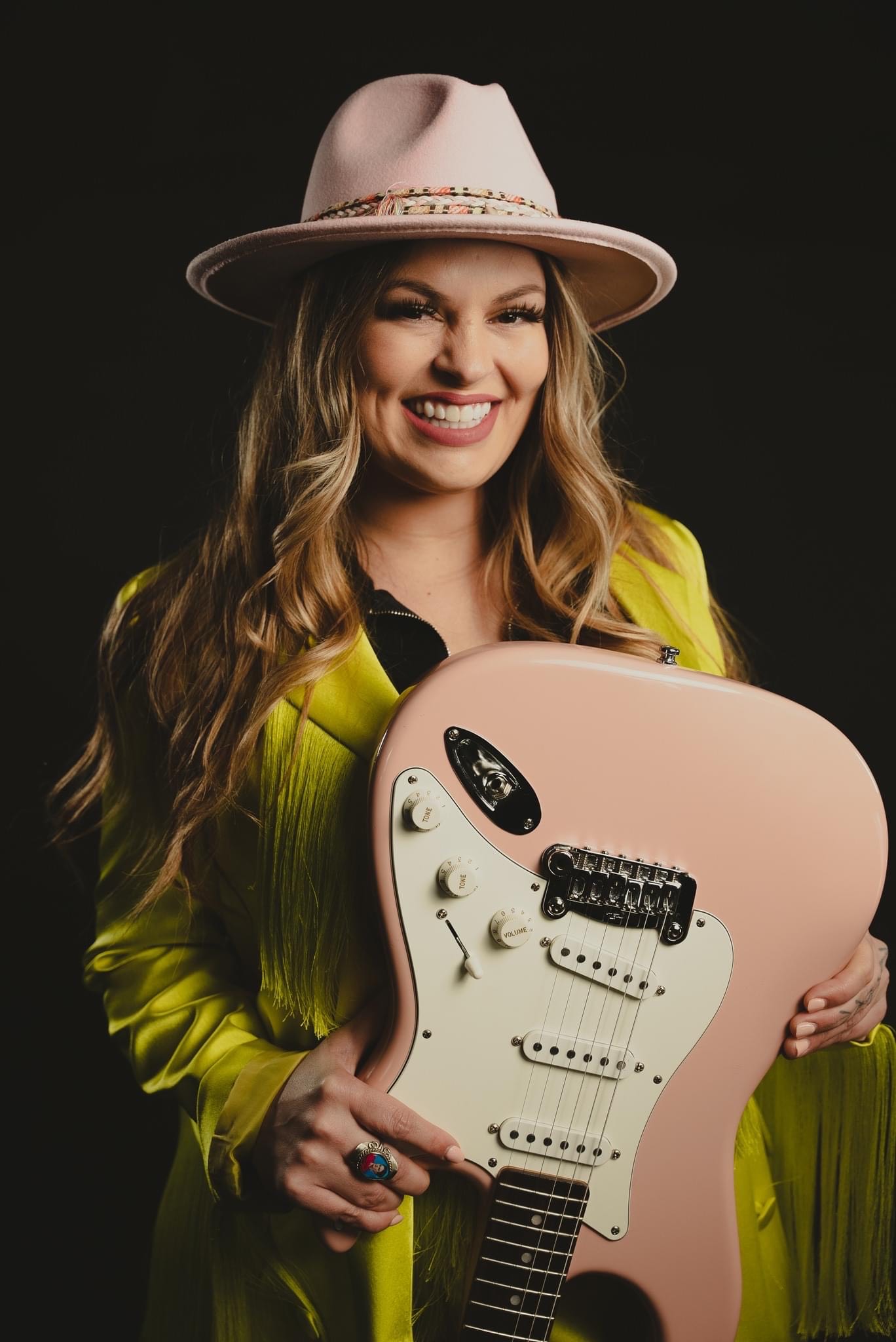 photo of singer/songwriter Nicki White with pink guitar and cowboy hat